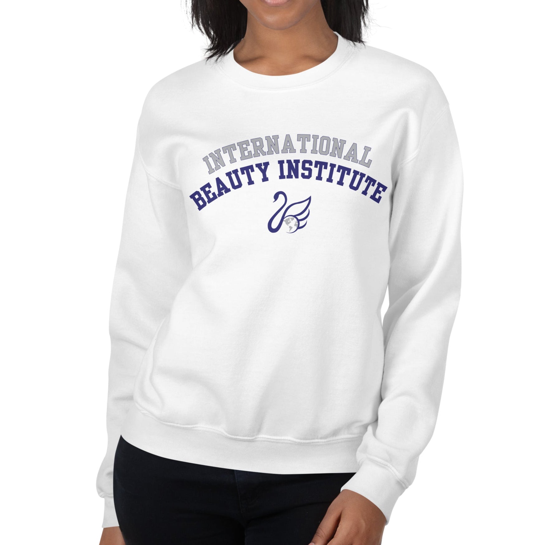Person wearing a white sweatshirt with 'International Beauty Institute' text on a white background